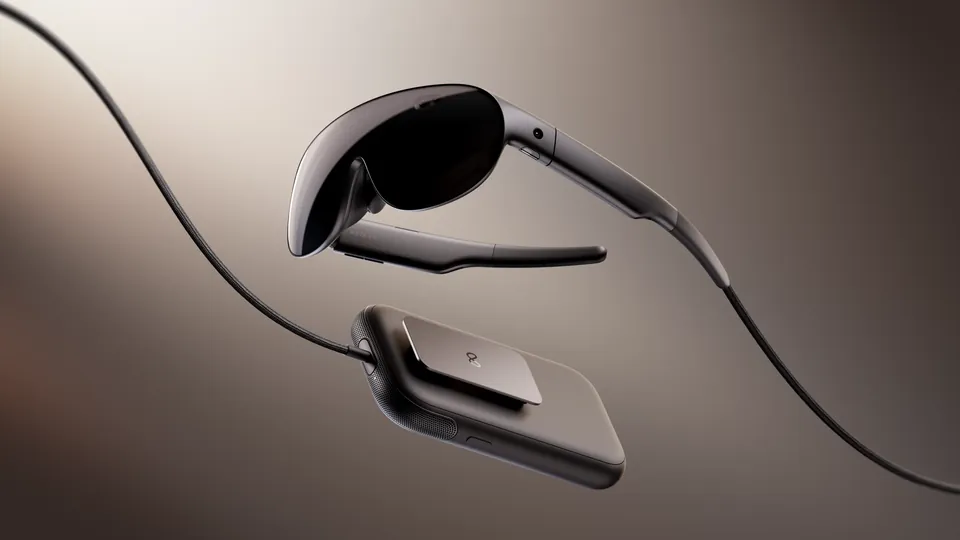 Meta VR Glasses, a slim wraparound headset on a cable, floating above its small compute puck against a dark brown-gray gradient
