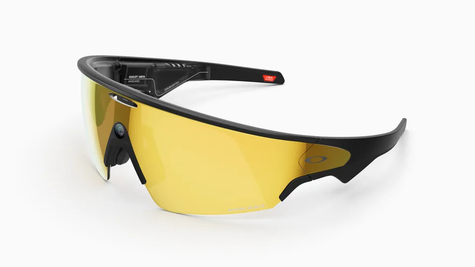Oakley Meta Vanguard glasses with a black frame and a large yellow mirrored wraparound lens, shown at an angle on a white background, with the camera at the nose bridge
