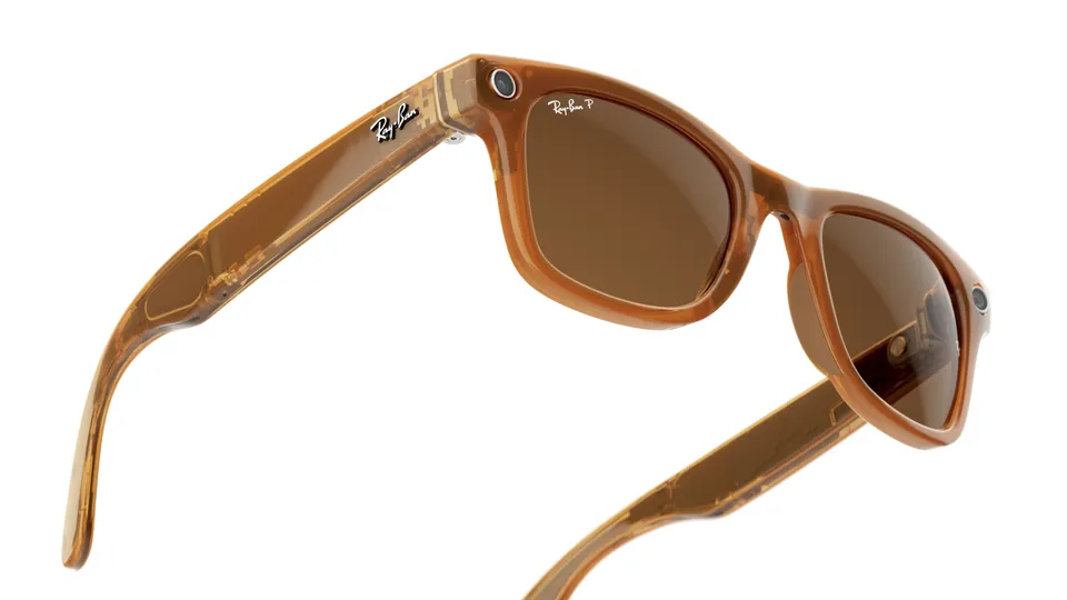 Ray-Ban Meta Wayfarer glasses with a translucent caramel frame and brown lenses, shown at an angle on a white background