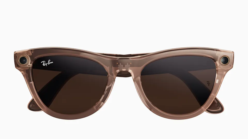 Front view of Ray-Ban Meta Skyler glasses in a translucent peach frame with brown lenses and a camera at each corner, on a white background
