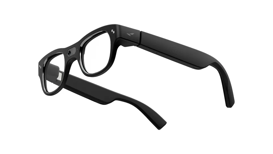 Three-quarter view of RayNeo X3 Pro glasses with a black frame, clear lenses and a camera at the nose bridge, on a white background