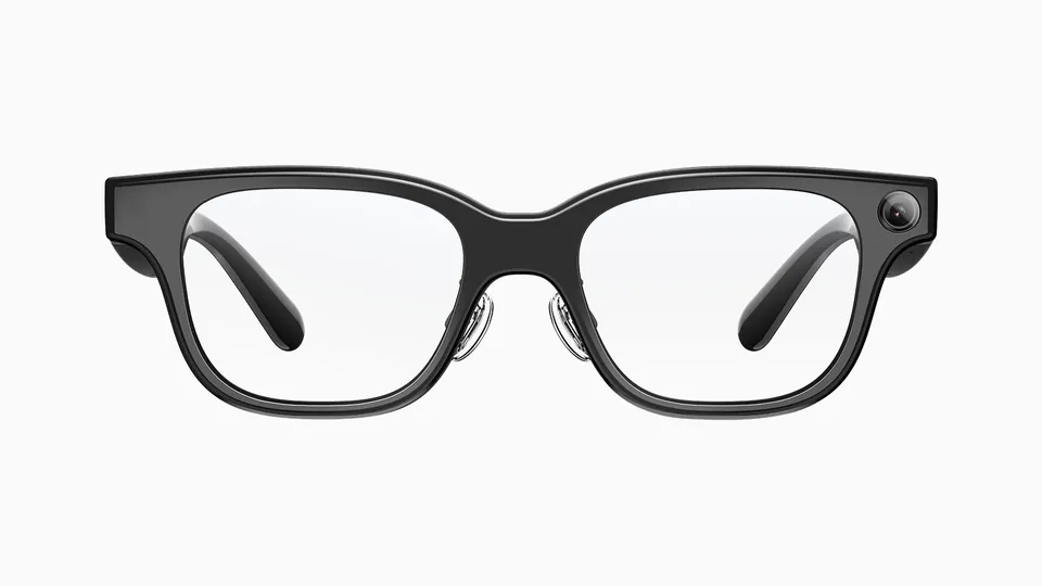 Front view of Rokid Glasses with a black rectangular frame, clear lenses and a camera at the right outer corner, on a plain white background
