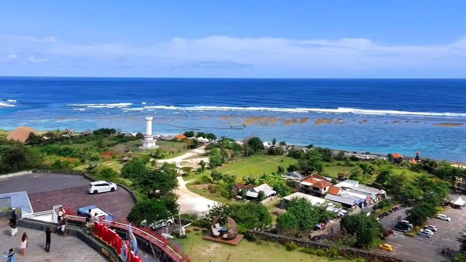 A seaside lookout above Pandawa Beach in Bali, with a few people on a terrace below and the ocean beyond